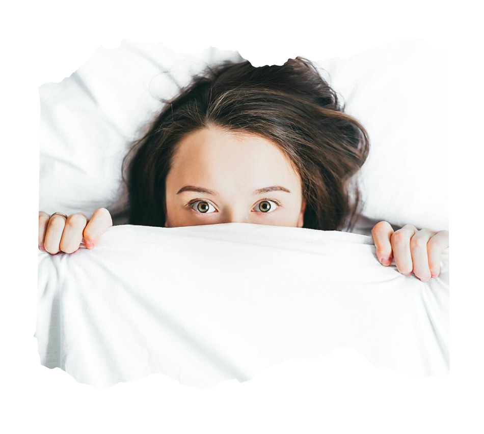 stressed woman in bed pulling up a blanket